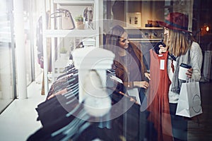 Birds of a feather shop together. two best friends out shopping in a clothing store.