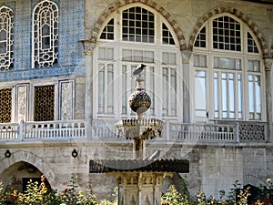 Birds in fountain in front of an arabic palace