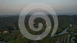 Birdseye view of a river flowing through a lush green forest landscape Nin-Binh Vietnam Asia 5K rotation drone view