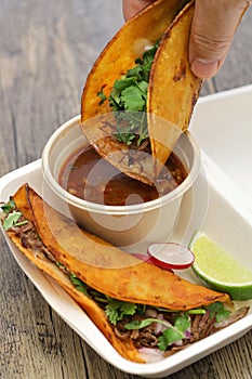 Birria tacos with broth for dipping, mexican food