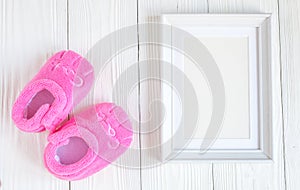 Birth of child - blank picture frame on wooden background