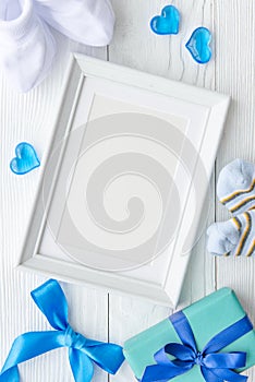 Birth of child - blank picture frame on wooden background