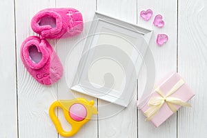 Birth of child - blank picture frame on wooden background