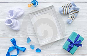 Birth of child - blank picture frame on wooden background