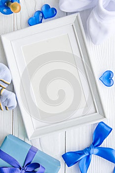 Birth of child - blank picture frame on wooden background