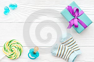 Birth of child - lollipop on wooden background