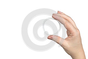 Birth control ring in a womans hand isolated on white background, vaginal ring for contraceptive use photo