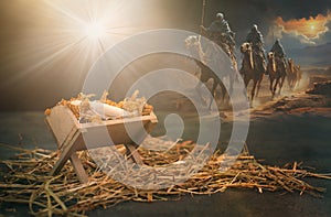 Birth of Jesus Christ in Bethlehem, star shinning on the manger, three kings riding on camels, desert night, religion and faith