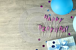 Birthday accessories on gray wooden background, space for text