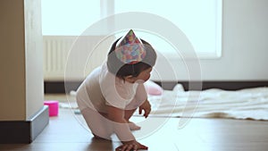 Birthday baby. Little girl, child, toddler sitting on floor at home, playing with little dog, crawling on floor.