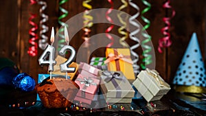 Birthday background with muffin and candles with number 42. Beautiful anniversary background with cake copy space with burning