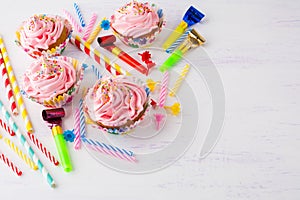 Birthday background with pink cupcakes and birthday candles