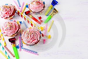 Birthday background with pink cupcakes and candles