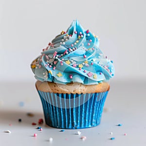 Birthday blue cupcake with butter cream icing isolated on white background