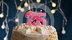 Birthday cake with 25 number pink candle on blue backgraund