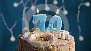 Birthday cake with 70 number candle on blue backgraund