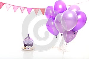 Birthday cake and balloons on white background in the studio