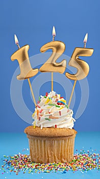 Birthday cake with candle number 125 - Blue background