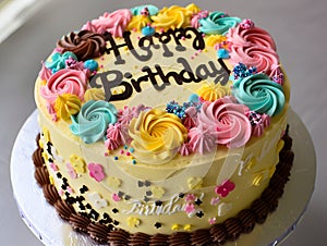 A birthday cake with colorful frosting and flowers