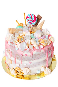 Birthday cake with decorated with candies, lollipop, marshmallows. Pink pastel color. Balloons on background. Isolated