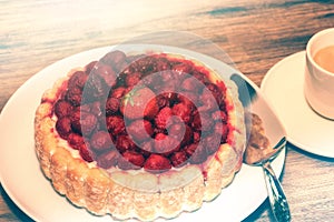 Birthday cake with fresh raspberries and coffee cup