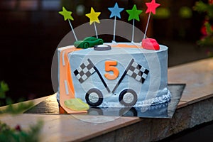 Birthday cake with mastic stars and cars figures for boy. 5 years old