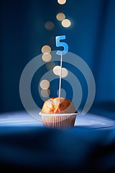 Birthday cake with number five 5 and lights on background