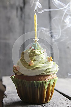 Birthday cake with one candle, floating smoke