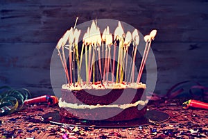 Birthday cake with some lit candles, filtered