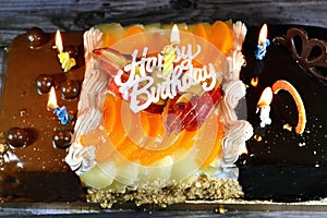 Birthday cake of three different pieces spongy creamy cake for celebrations, hazelnut chocolate spread, dark chocolate, caramel,
