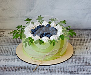 birthday cake wrapped in biscuit tape with blueberries and merengues