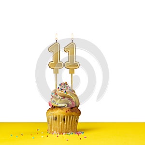Birthday candle number 11 - Cupcake on white background
