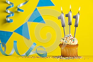 Birthday candle number 111 with cupcake - Yellow background with blue pennants