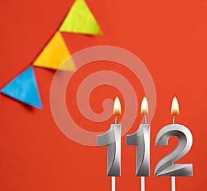 Birthday candle number 112 - Invitation card in orange background