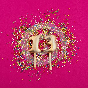 Birthday candle number 13 - Anniversary celebration in rhodamine red background