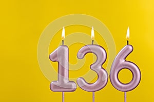 Birthday candle number 136 - Birthday celebration on yellow background