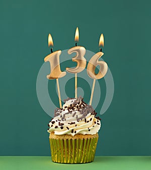 Birthday candle number 136 - Vertical anniversary card with green background