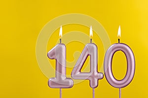 Birthday candle number 140 - Birthday celebration on yellow background