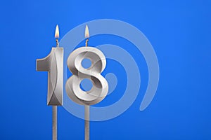 Birthday candle number 18 - Celebration card on blue background