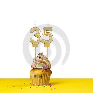 Birthday candle number 35 - Cupcake on white background