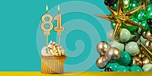 Birthday candle number 81 - Cupcake with decoration on a green background