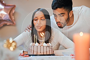 Birthday, candles and couple blow cake at party for celebration, surprise and present. Happy, flame and young man and