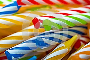 birthday candles, thin brightly colored candles used to mark the years celebrated on the cake.