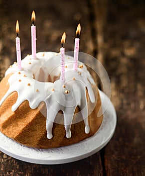 Birthday candles on a twirled vanilla ring cake