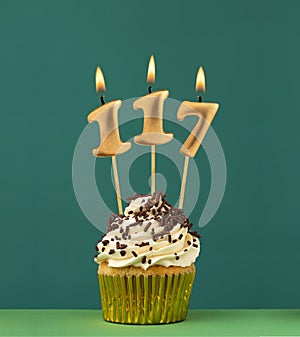 Birthday card with candle number 117 - Green background