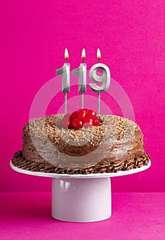 Birthday card with candle number 119 - Chocolate cake on pink background