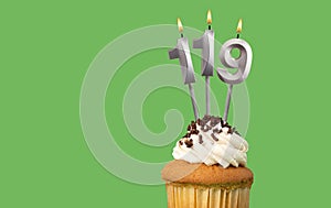 Birthday card with candle number 119 - Cupcake on green background