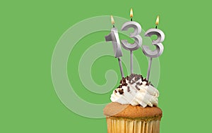 Birthday card with candle number 133 - Cupcake on green background
