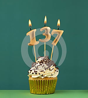 Birthday card with candle number 137 - Green background