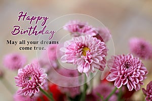Birthday card and greeting concept. With birthday wishes message - May all your dreams come true. On background of pink flowers.